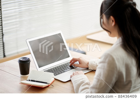 Asian woman working in a coworking space Asian woman working in a coworking space 88436409
