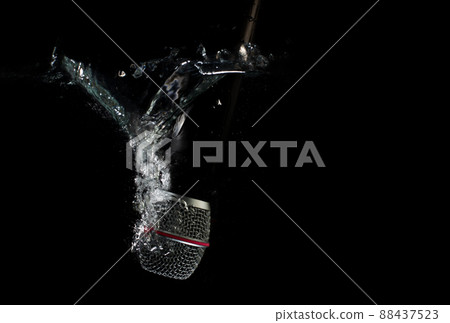 Microphone underwater - sinking mic. Professional microphone in water - concept. Microphone underwater - sinking mic. Professional microphone in water - concept. 88437523