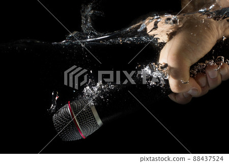 Microphone Sinking - underwater mic. Holding a microphone in hand under water. Microphone Sinking - underwater mic. Holding a microphone in hand under water. 88437524