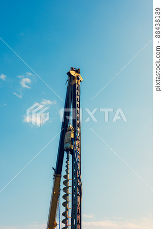 Pile driver Crane towering over the... - Stock Photo [88438189