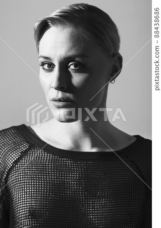 Elegantly alluring. Black and white image of a beautiful woman posing in casual wear. Elegantly alluring. Black and white image of a beautiful woman posing in casual wear. 88438686