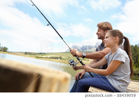 Shes already an expert angler. Shot of a father showing his daughter how to fish. Shes already an expert angler. Shot of a father showing his daughter how to fish. 88439059