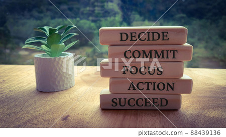 Text on wooden blocks - Decide, Commit, Focus, Action and Succeed. Plant and blurred nature background. 88439136