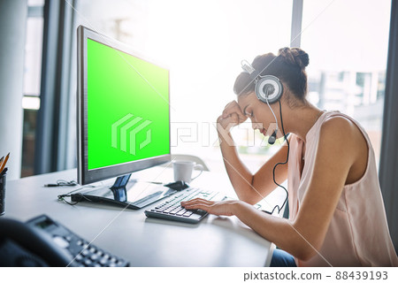 Sometimes helping people is difficult. Cropped shot of an attractive young woman looking stressed while working in a call center. Sometimes helping people is difficult. Cropped shot of an attractive young woman looking stressed while working in a call center. 88439193