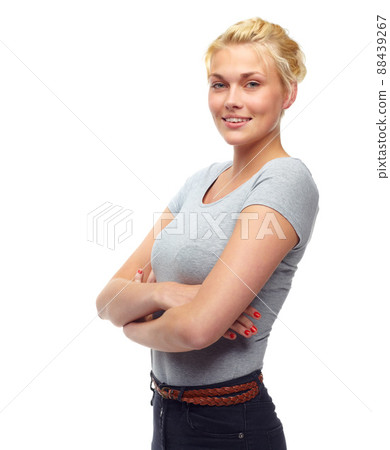 Young and confident. Studio shot of a beautiful young woman with her arms crossed isolated on white. Young and confident. Studio shot of a beautiful young woman with her arms crossed isolated on white. 88439267