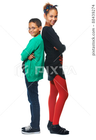 Youth in isolation. A studio shot of two adorable kids standing back to back. 88439274