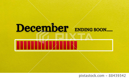 Top view of loading bar showing the end of December month with yellow paper background. 88439342