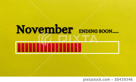 Top view of loading bar showing the end of November month with yellow paper background. 88439346