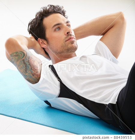 Getting a six pack starts here. A handsome young man doing sit-ups. Getting a six pack starts here. A handsome young man doing sit-ups. 88439553