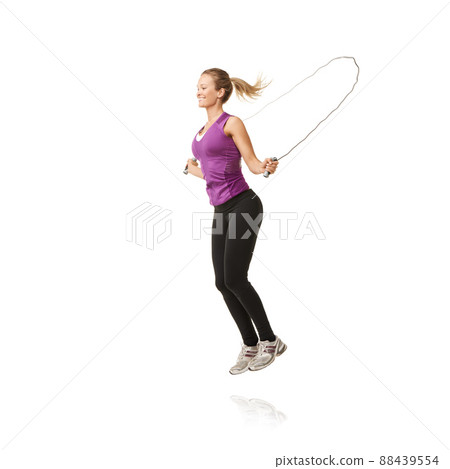 Im flying through the air. A beautiful young woman skipping. 88439554