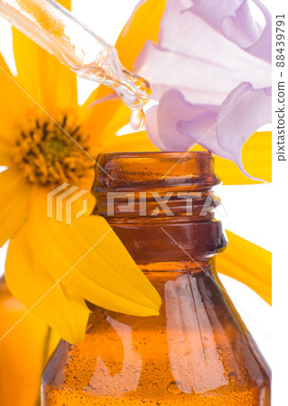 Drop falling from dropper of essential oil. Natural Remedies. 88439791