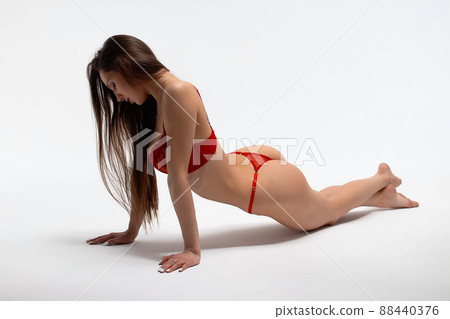Beautiful woman laying in underwear in studio Beautiful woman laying in underwear in studio 88440376