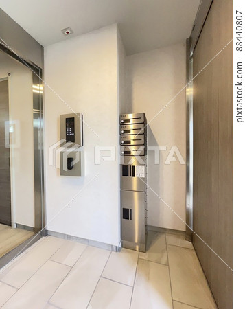 Entrance of an apartment with an auto-lock delivery box Entrance of an apartment with an auto-lock delivery box 88440807