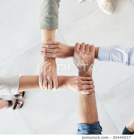 Developing a good work ethic is key. Cropped shot of a group of businesspeople linking their arms in solidarity at work. Developing a good work ethic is key. Cropped shot of a group of businesspeople linking their arms in solidarity at work. 88440837