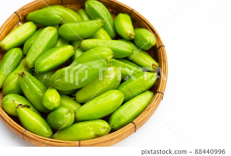 Bilimbi fruit in bamboo basket on white background. 88440996