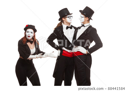 Portrait of three mime artists performing, isolated on white background. Two men embrace, and the girl is perplexed. Symbol of tolerance, same-sex marriage, the LGBT community 88441584