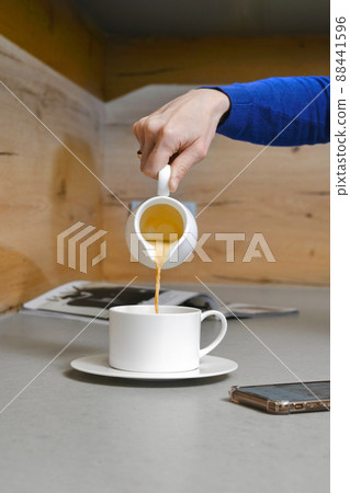 Pouring soy milk into coffee 88441596