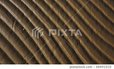 Stripes of fine sea sand on the coast. Natural background from the sand of the sea. 88441810