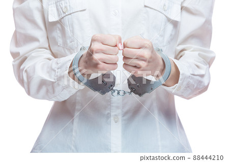 Female hands with handcuffs, on a white background Female hands with handcuffs, on a white background 88444210