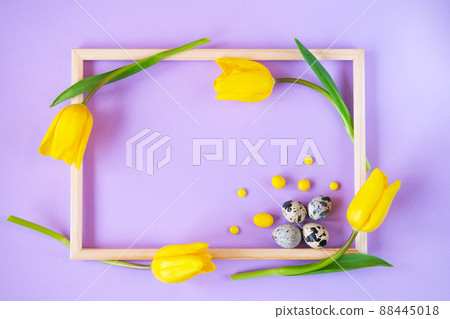 Easter eggs, tulips and candies in a frame. Spring holiday background. 88445018