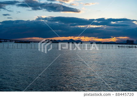 Photographing the sunrise over Lake Biwa from the shore of Lake Katata, Otsu City, Shiga Prefecture Photographing the sunrise over Lake Biwa from the shore of Lake Katata, Otsu City, Shiga Prefecture 88445720