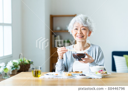 Senior woman eating 88446796