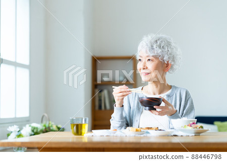Senior woman eating 88446798