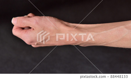 Lean man's arm and raised blood vessels 88448133