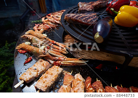 Tomahawk rib beef steak and T-bone on hot black grill. Tomahawk rib beef steak and T-bone on hot black grill. 88448733