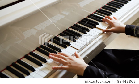 Womans hands on the keyboard of the piano closeup 88448865