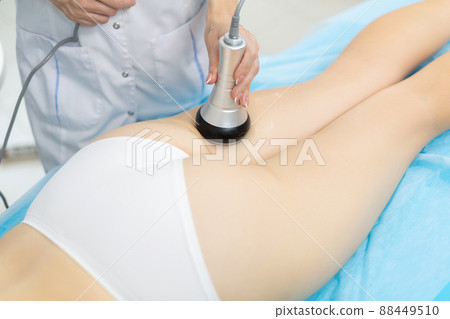 Close up shot of a relaxed woman getting RF lifting endospheres therapy massage at spa center. Due to the deep heating of muscle tissues, a fast and stable lifting effect is achieved, the process of 88449510