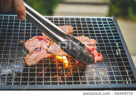 Close up of grilling meat on the charcoal grill. Close up of grilling meat on the charcoal grill. 88449559