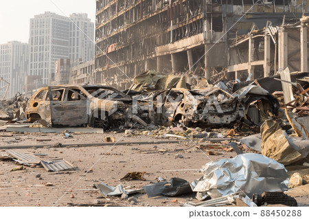 2022 Russian invasion of Ukraine war torn city destroyed car burn out. War crime Russia bombed building damage cars destruction city ruins building insurance car. Terror attack bomb damage war ruins 88450288
