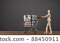 A man carries a cart from a supermarket with money 88450911
