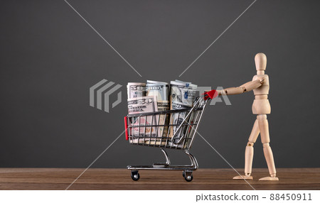 A man carries a cart from a supermarket with money A man carries a cart from a supermarket with money 88450911