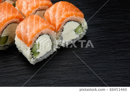 Philadelphia roll sushi with salmon, cucumber and cream cheese on black background for menu. Japanese food 88451460