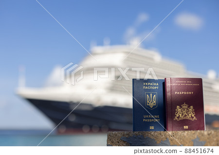 Female hand holding Ukrainian passport on the background of the sea. Female hand holding Ukrainian passport on the background of the sea. 88451674