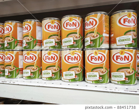 SELANGOR, MALAYSIA -APRIL 4, 2022: Sweetened creamer and evaporated milk packed in cans. Displayed for sale on the rack inside the supermarket. The main ingredient is made from palm oil seeds. SELANGOR, MALAYSIA -APRIL 4, 2022: Sweetened creamer and evaporated milk packed in cans. Displayed for sale on the rack inside the supermarket. The main ingredient is made from palm oil seeds. 88451738