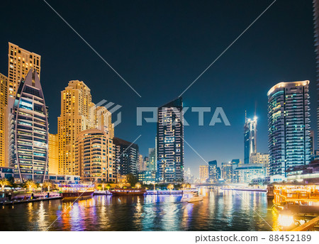 Night view of skyscraper of residential district in Dubai Marina And Tourist Boat, Sightseeing Boat Sailing On Dubai Marina 88452189