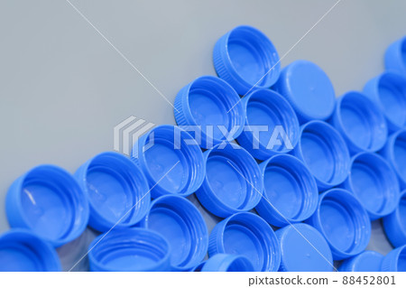 Close up: many blue plastic bottle caps moving on conveyor belt, production line Close up: many blue plastic bottle caps moving on conveyor belt, production line 88452801
