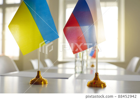 Ukrainian and Russian flags at negotiations aimed at stopping war and restoring peace 88452942