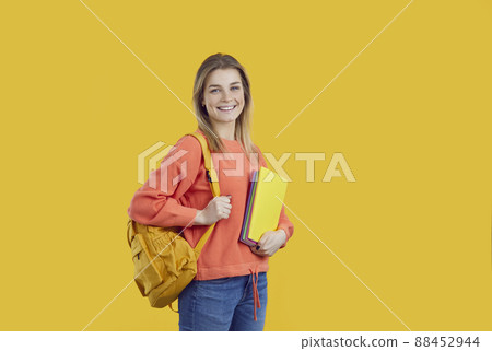 Happy university student with backpack and notebooks isolated on color background 88452944