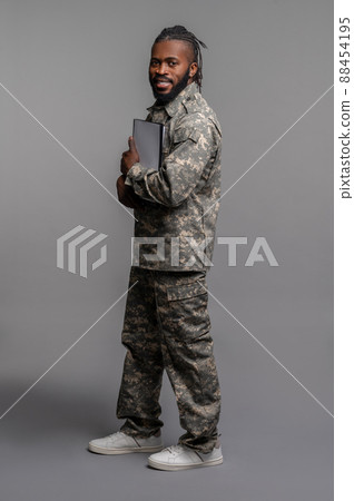 Young soldier pressing documents to his chest Young soldier pressing documents to his chest 88454195