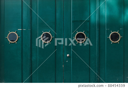 Green old wooden painted door with windows. Grunge texture for background. Green old wooden painted door with windows. Grunge texture for background. 88454339