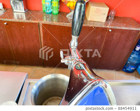 The beer taps in a pub. nobody. Selective focus. Alcohol concept. Vintage style. Beer craft. Bar table. Steel taps. Shiny taps The beer taps in a pub. nobody. Selective focus. Alcohol concept. Vintage style. Beer craft. Bar table. Steel taps. Shiny taps 88454911