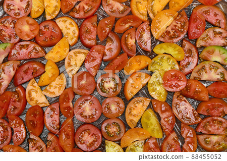 Slice tomato on black background Slice tomato on black background 88455052