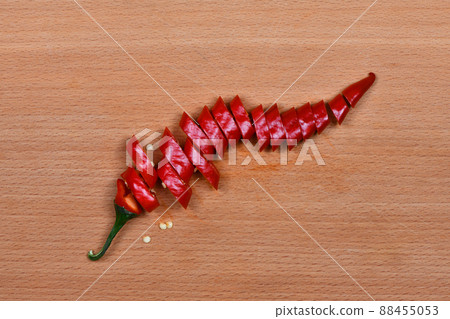Chop hot pepper on dark wood background 88455053