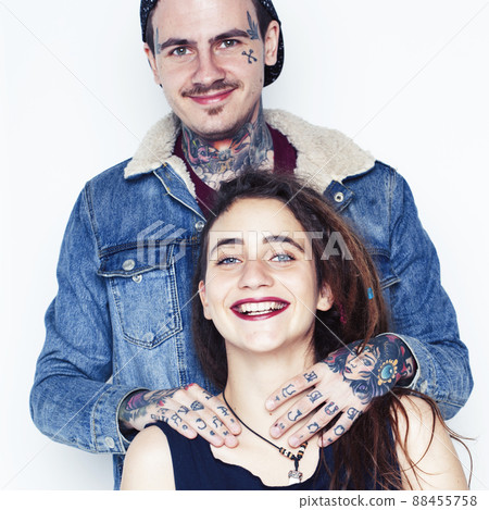Young couple together. guy with tattoo, girlfriend wearing dreadlocks having fun on white background 88455758