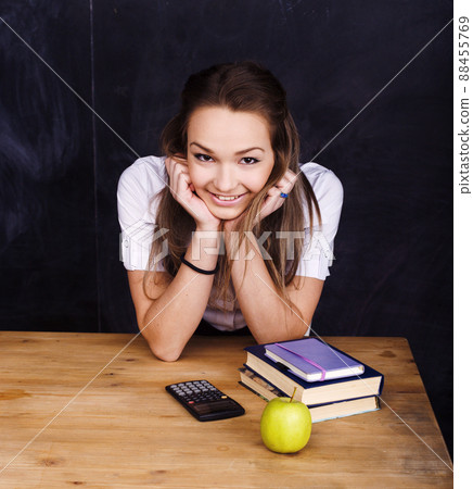 portrait of happy cute student with book in classroom 88455769