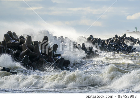 coastal storm in the baltic sea, big waves crash against the harbor breakwater 88455998